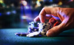 Hand,Betting,Game,Chips,On,Felt,Mat,With,Game,Room